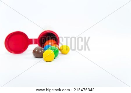 Colorful, popular peanuts with sugar glazure in front of the package isolated on white background.
