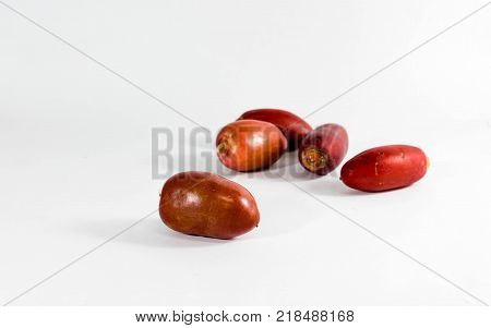 Close up of fresh red date fruits on while background