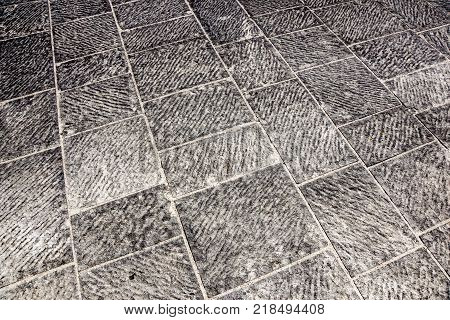 abstract pattern. Outdoor street tiles with geometric pattern.The texture of perspective colored checkered tile in the street. Abstract geometrical brick stone pavement yellow and gray pattern.