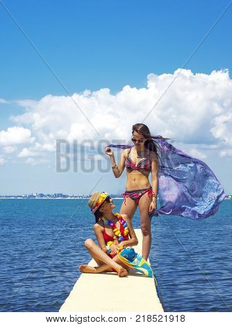 Two beautiful women, has haired long hair, red bikini, poreo, sunglasses, slim body, happy smile face. Tropical hot sea.