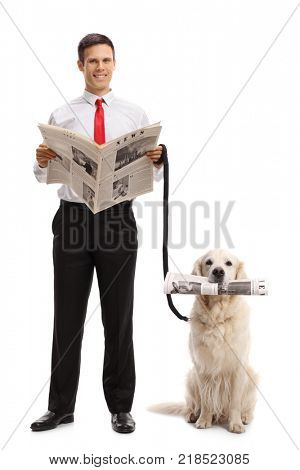 Full length portrait of an elegant guy with a newspaper and a labrador retriever dog with a newspaper isolated on white background