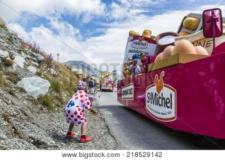 Col de la Croix de Fer France - 25 July 2015: Kid in Polka-Dot Jersey enjoying the passing of the Publicity Caravan on the road to the Col de la Croix de Fer in Alps during the stage 20 of Le Tour de France 2015.