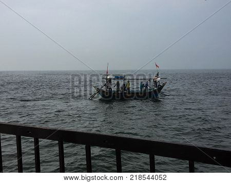 Six fisherman fishing near Pulau Ayer in Jakarta, Indonesia.