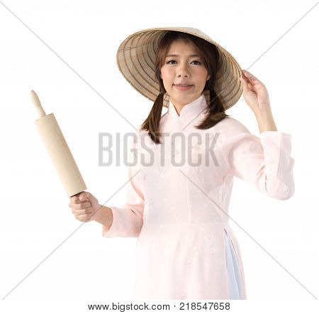 beautiful woman in pink dress and vietnam hat holding rolling pin. isolated background with clipping path.