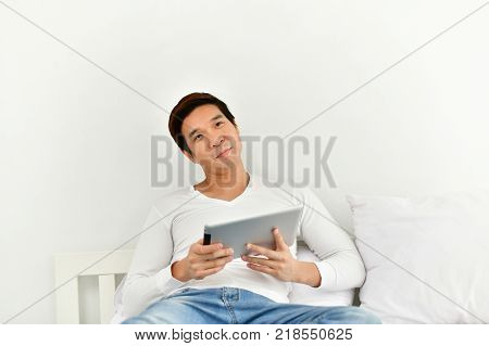 Men are playing mobile in the bedroom.