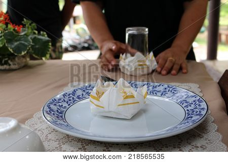 Asian women are practice folding the fabric nepkin.Thailand.