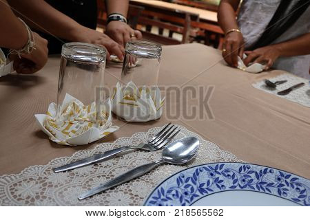 Asian women are practice folding the fabric nepkin.Thailand.