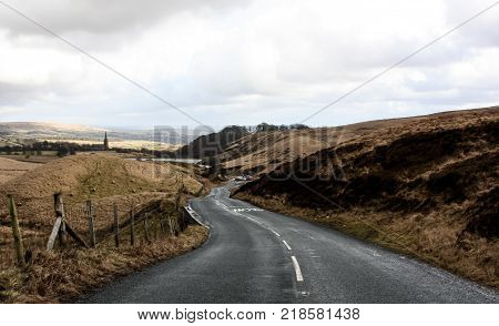 The tarmac road that winds down the hill towards the village of Belmont