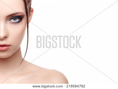 Half-face portrait of beautiful sensitive woman with fresh clean skin wet effect on her face and body high fashion and beauty portrait creative makeup theme strobing or highlighting makeup