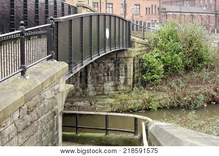 A small metal bridge over the canal in the centre of Wigan