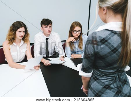 reprimand of a guilty office worker woman. strict bosses. daily routine of working people.