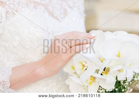close-up of a bride holding a wedding bouquet. The concept of a wedding festival and a happy life
