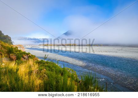 Yellow forest and river in New Zealand Alps