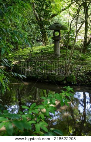 Kanazawa - Japan, June 9, 2017: Historical stone lantern in Gyokuseninmaru Garden at Kanasawa castle in springtime