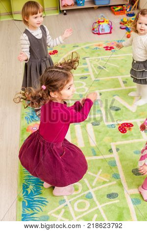 Group of little children dancing and claping in hands