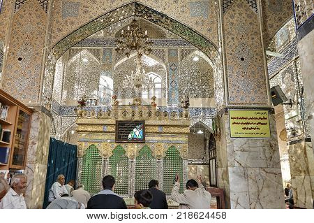 Yazd Iran - April 21 2017: Shrine of Prince Fazel Men sit on carpet and pray in prayer hall of Sahhzade Fazel Holy Shrine.
