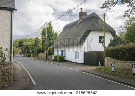 Street view of a thatched cottage in the pretty village of Fowlmere Cambridgeshire England UK