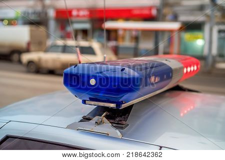 The roof-mounted activated lightbar of police vehicle