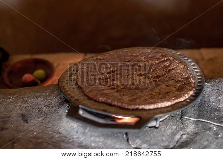 Hot homemade flatbread made of sorghum flour as a part of traditional rustic ethnic Srilankan cuisine