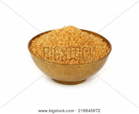 Vintage metal bowl full of brown cane sugar