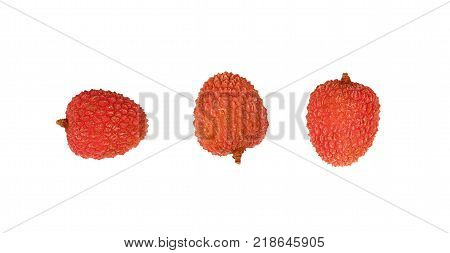 Three fresh red ripe lychee (Litchi chinensis) tropical fruits isolated on white background detail close up in different perspectives elevated top view directly above