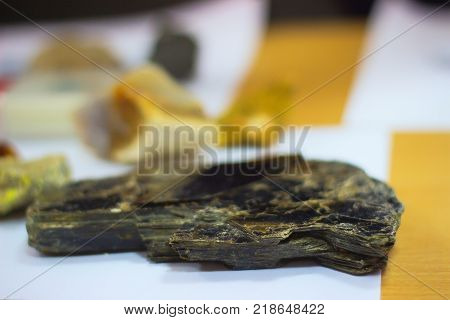 The pattern of the variegated sandstones. Layers of toned colored mica stones. Rock Landslide. Shiny silicate mineral