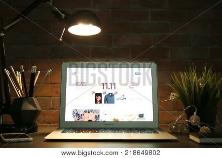 KYIV, UKRAINE - NOVEMBER 10, 2017: Apple MacBook Air Silver with eBay homepage on screen in dark room