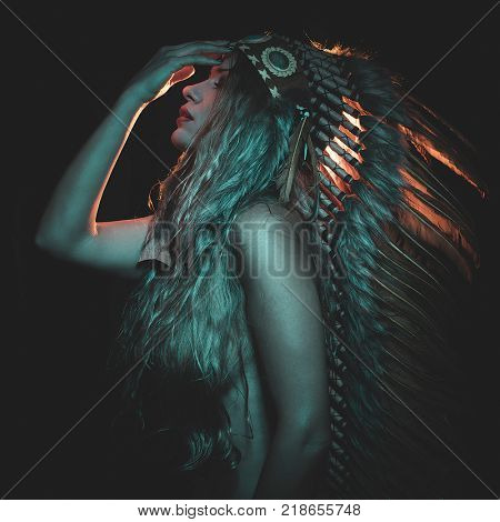 Faith, beautiful girl with plume of american indian feathers