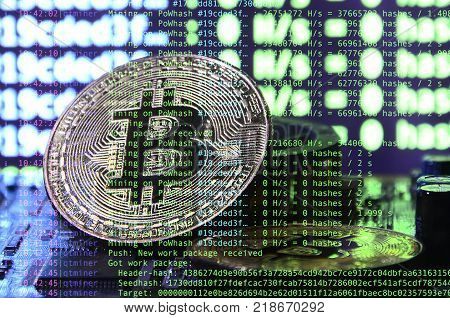 Image of the program code showing the process of mining the crypto currency in the background of the image with bitcoin