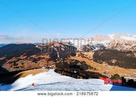 Selva di Val Gardena, Italy slopes in winter. People snowboarding and skiing down the Dolomite Alps mountains in Val Gardena, Italy.