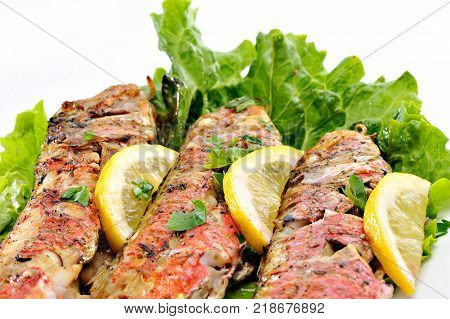 Grilled red fish with lettuce and lemon