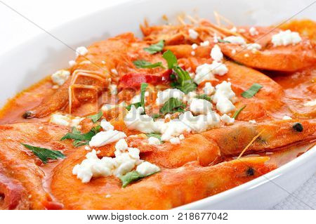 Shrimps with cheese and tomato in a plate