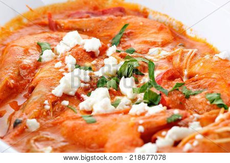 Shrimps with cheese and tomato in a plate