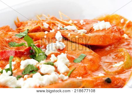 Shrimps with cheese and tomato in a plate