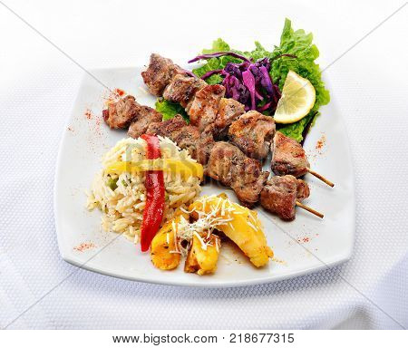 Greek Souvlaki with rice and fried potatoes