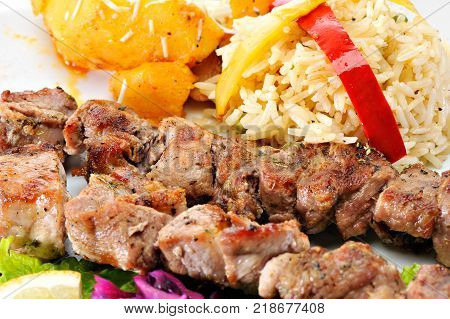 Greek Souvlaki with rice and fried potatoes