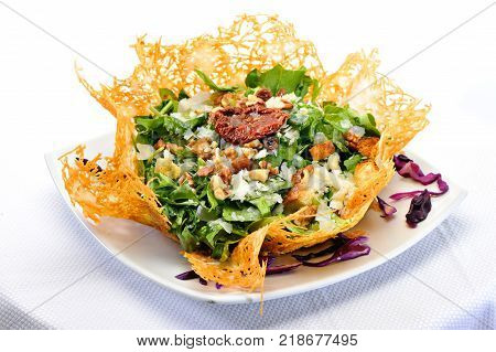 Rocca Salad with dried tomato in cheese bowl