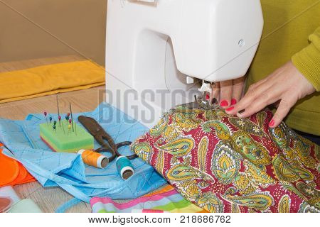 woman hands sewing cloth In Studio. Tailor hands working with scissor and suit textile cloth