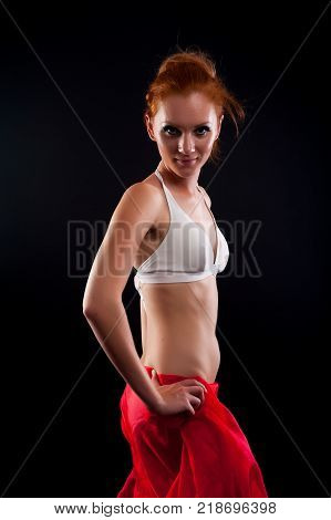 portrait of a beautiful adult sensuality woman in white bikini at black background