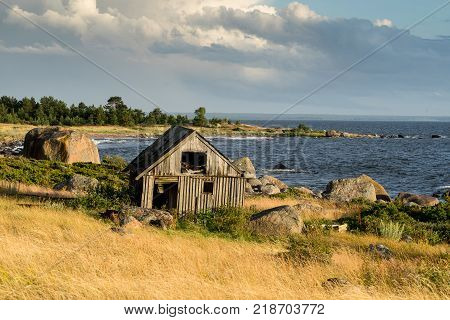 Abandoned houses in the Baltic Sea. Shore, nature and ruins facilities architecture concept. Mohni, small island in Estonia, Europe.