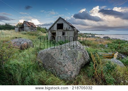 Abandoned houses in the Baltic Sea. Shore, nature and ruins facilities architecture concept. Mohni, small island in Estonia, Europe.