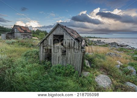 Abandoned houses in the Baltic Sea. Shore, nature and ruins facilities architecture concept. Mohni, small island in Estonia, Europe.
