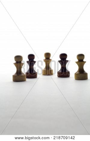 black and white chess pawns on a white background . Business or game or socium or society concept