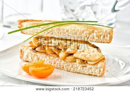 Chicken sandwich served with mushrooms and cheese.
