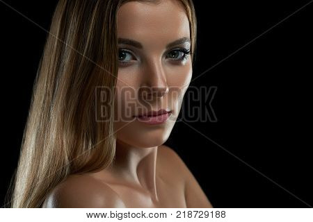 Close up of a stunning young woman posing seductively at studio on dark background beauty fashion modelling glamour feminine skin perfection unblemished care body sensuality concept.