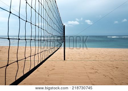 Volleyball net on the sand beach on tropical island. Sport during vacation