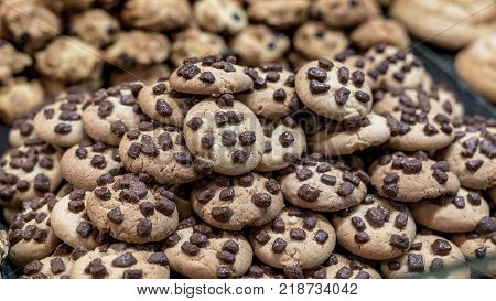Assortment of homemade chocolate chip cookies on a pastery window