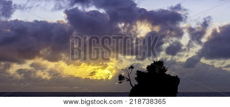 Dramatic sunrise over the Adriatic Sea with Kamen Brela - Tiny famous island in Brela, Makarska Riviera, Croatia