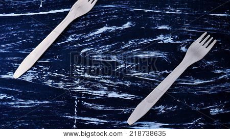 Silver fork lying on a wooden table.