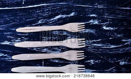 Silver fork lying on a wooden table.